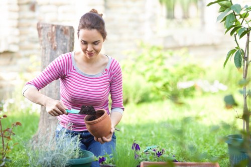 Gardeners in Lea Bridge shaping privacy planting