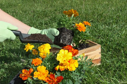 Team member using protective equipment during garden maintenance